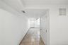 Corridor featuring light tile patterned flooring