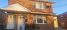 View of front of house featuring brick siding and a porch