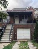 View of front of home featuring stairway and a balcony