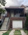 View of front of home featuring stairway and a balcony