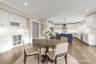 Dining room featuring ornamental molding, wine cooler, dark wood finished floors, a bar, and recessed lighting