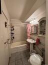 Full bath featuring shower / bath combination with curtain and tile patterned flooring