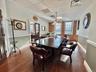 Dining area featuring wood finished floors and brick wall
