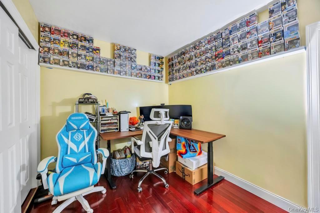Office with hardwood / wood-style flooring and baseboards