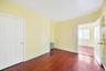 Spare room with dark wood finished floors and radiator heating unit