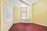 Empty room featuring baseboards and dark wood-type flooring