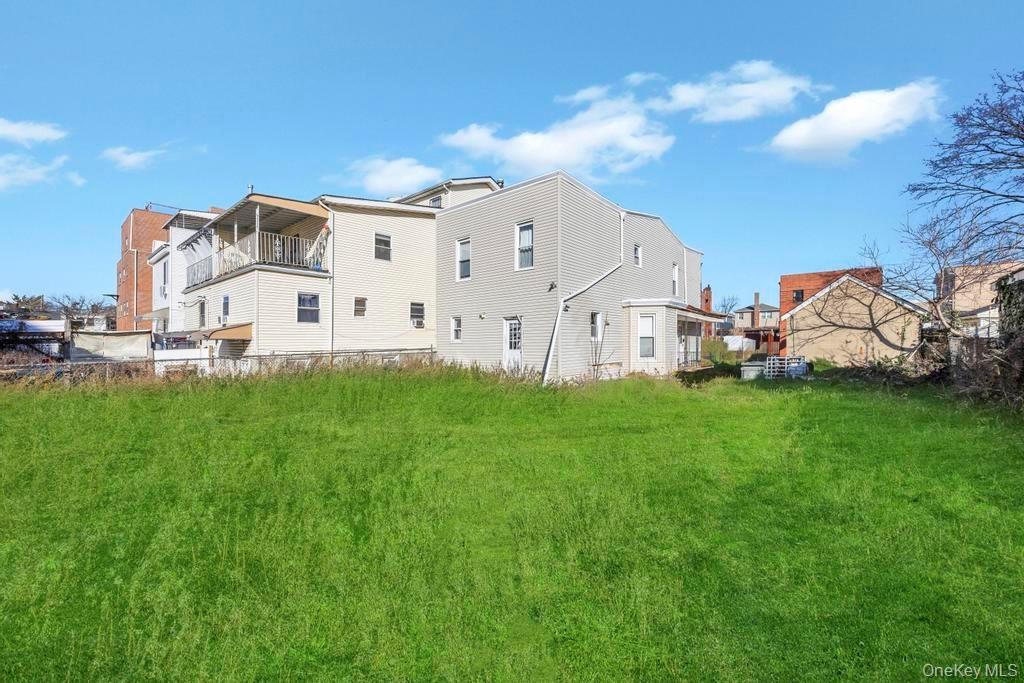 Back of house with a balcony