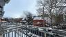 Snow covered back of property with a residential view