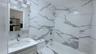 Full bathroom featuring tile walls, vanity, and  shower combination