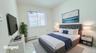 Bedroom featuring light marble finish flooring and baseboard heating