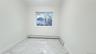 Spare room with light marble finish floors and a baseboard heating unit