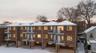 Back of property with a balcony and brick siding
