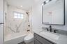 Bathroom featuring a combined bath / shower with marble appearance, vanity, and recessed lighting. For Marketing Purposes!