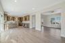 Unfurnished living room with light wood-type flooring, wine cooler, and recessed lighting. For Marketing Purposes!