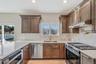Kitchen with stainless steel appliances, under cabinet range hood, a peninsula, backsplash, and recessed lighting. For Marketing Purposes!