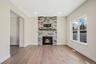 Unfurnished living room featuring a stone fireplace, light wood-type flooring, and recessed lighting. For Marketing Purposes!