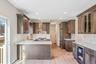 Kitchen with light stone countertops, a peninsula, beverage cooler, glass insert cabinets, and recessed lighting. For Marketing Purposes!
