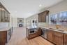 Kitchen with decorative backsplash, open floor plan, a peninsula, a fireplace, and recessed lighting. For Marketing Purposes!