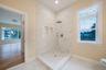 Bathroom featuring light marble finish floors, plenty of natural light, and a marble finish shower. For Marketing Purposes!