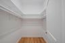 Walk in closet featuring light wood-type flooring. For Marketing Purposes!