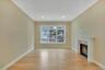Unfurnished living room with a glass covered fireplace, light wood-type . For Marketing Purposes!flooring, ornamental molding, and recessed lighting
