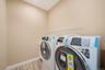 Washroom with washing machine and dryer and wood finish floors. For Marketing Purposes!