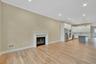 Unfurnished living room featuring recessed lighting, light wood-type flooring, a glass covered fireplace, and ornamental molding. For Marketing Purpos