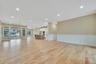 Unfurnished living room with a decorative wall, wainscoting, recessed lighting, and light wood-type flooring. For Marketing Purposes!