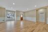 Unfurnished living room featuring wainscoting, recessed lighting, light wood-style floors, ornamental molding, and a decorative wall. For Marketing Pu