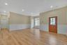 Foyer entrance with wainscoting, light wood-style flooring, a decorative wall, and crown molding. For Marketing Purposes!