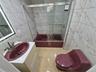 Full bath with tile walls, shower / bath combination with glass door, and vanity