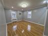 Spare room featuring recessed lighting, crown molding, light wood-type flooring, radiator, and a wall unit AC