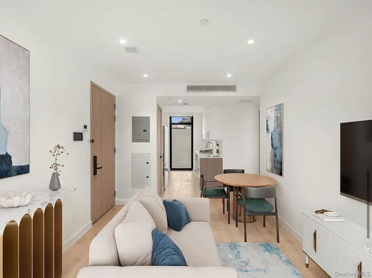 Living area featuring recessed lighting, electric panel, and light wood-style flooring