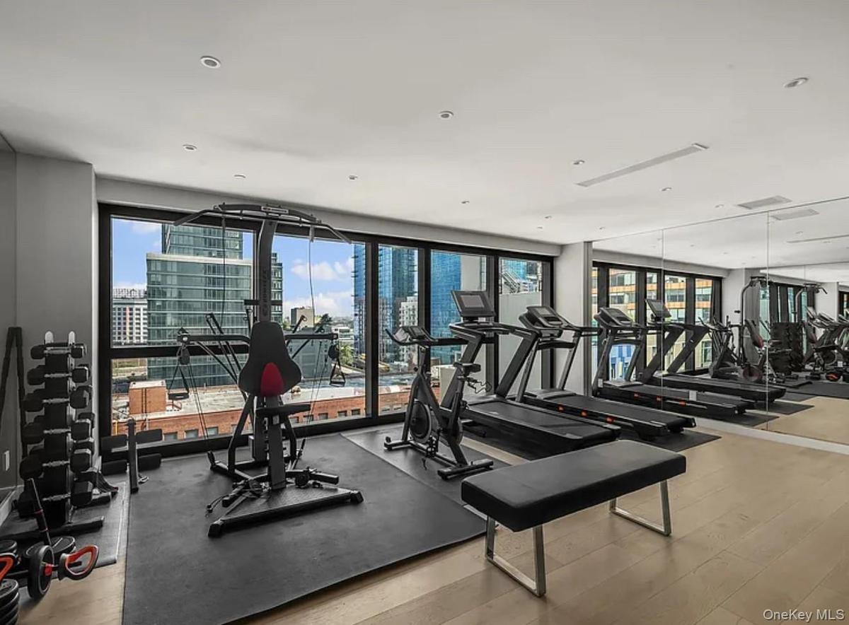 Exercise room featuring a city view
