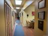 Hallway featuring wood finished floors and baseboards