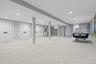 Below grade area with light colored carpet and recessed lighting