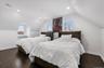 Bedroom with vaulted ceiling, dark wood-style flooring, and recessed lighting