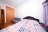 Bedroom featuring wood finished floors, lofted ceiling, and a closet