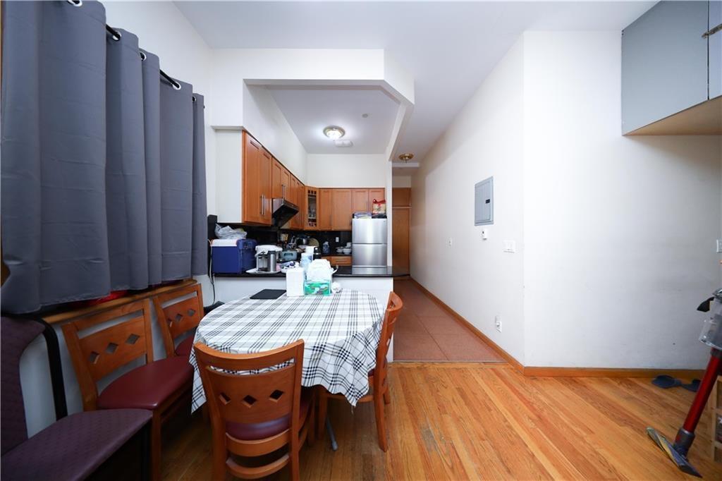 Dining area featuring electric panel, baseboards, and light wood-style flooring