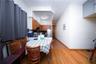 Dining area featuring electric panel, baseboards, and light wood-style flooring
