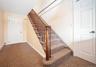 Staircase featuring carpet flooring
