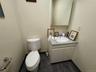 Half bath with vanity and dark tile patterned flooring