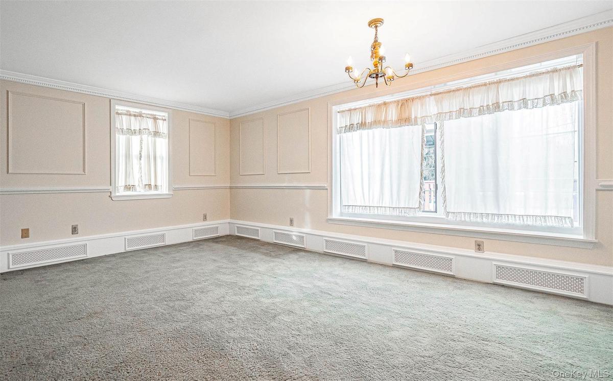 Dining room featuring a decorative wall and a chandelier