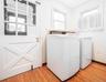 Laundry room featuring light wood-type flooring and washing machine and clothes dryer