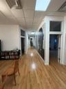 Corridor featuring a paneled ceiling and light wood-type flooring