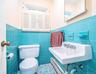 Bathroom with tile patterned floors, and tile walls