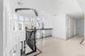 Hall featuring an upstairs landing, crown molding, and inlaid floor details