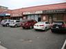 View of commercial property featuring uncovered parking