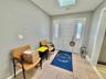 Entryway with a skylight and light tile patterned floors