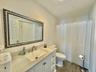 Bathroom featuring vanity, a shower with curtain, and dark wood finished floors